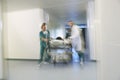 Physicians Moving Patient On Gurney Through Hospital Corridor Royalty Free Stock Photo