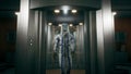 The physicist leaves the elevator and walks down the corridor into the room with the fusion reactor. 3D Rendering. Royalty Free Stock Photo