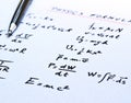 Physics formulas written on a white paper
