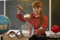 A physics teacher conducts an experiment with an Electrometer.