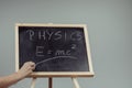 Physics word and formula E=mc2 on chalkboard Royalty Free Stock Photo