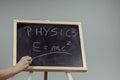 Physics word and formula E=mc2 on chalkboard Royalty Free Stock Photo