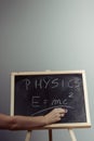 Physics word and formula E=mc2 on chalkboard Royalty Free Stock Photo