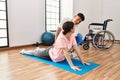 Physioterapist man giving treatment to woman at the clinic Royalty Free Stock Photo