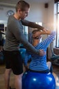 Physiotherapist assisting senior woman in exercise