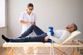 Physiotherapist Checking Man Patient Knee Royalty Free Stock Photo