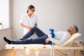 Physiotherapist Checking Man Patient Knee Royalty Free Stock Photo