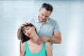 Physiotherapist checking pregnant womans neck