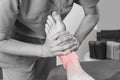 Physiotherapist, chiropractor doing a feet massage to man patient. Osteopathy