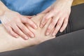 Physiotherapist, chiropractor doing a patellar mobilization, Knee pain. Spraining torn ligaments Royalty Free Stock Photo