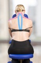 Physiotherapist, chiropractor putting on pink kinesio tape on woman patient. Pink: cervical, trapezius, supraspinatus, blue: high Royalty Free Stock Photo