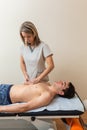 physiotherapist does session to man. dorsal manipulation, thrust, lumbar roll