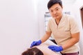 Physiotherapist doing acupuncture on woman`s back