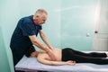 Physiotherapist doing back massage to her patient in medical office Royalty Free Stock Photo