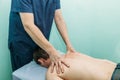 Physiotherapist doing back massage to her patient in medical office Royalty Free Stock Photo