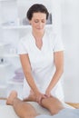 Physiotherapist doing calf massage to her patient Royalty Free Stock Photo