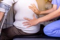 Physiotherapist doing treatment to senior woman patient in clinic ,Eldery women suffering from low-back lumbar pain,Physical thera Royalty Free Stock Photo