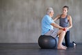 Physiotherapist, dumbbells and happy elderly man on ball for fitness or rehabilitation at gym on mockup. Senior person Royalty Free Stock Photo