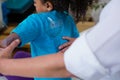 Physiotherapist examining girl patients back with goniometer