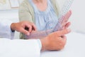 Physiotherapist examining patients wrist with goniometer Royalty Free Stock Photo