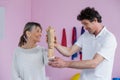 Physiotherapist examining a senior womans wrist