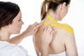 Physiotherapist getting taping on the trapezius woman Royalty Free Stock Photo