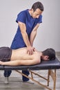 Physiotherapist giving a back massage. Chiropractic, osteopathy, manual therapy, acupressure Royalty Free Stock Photo