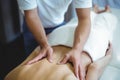 Physiotherapist giving back massage to a woman