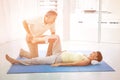 Physiotherapist giving physiotherapy to pregnant woman Royalty Free Stock Photo