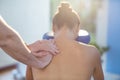 Physiotherapist giving shoulder massage to a female patient Royalty Free Stock Photo