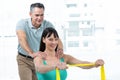 Physiotherapist guiding pregnant woman with exercise Royalty Free Stock Photo