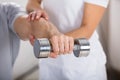 Physiotherapist Helping Man To Exercise