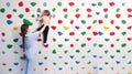 physiotherapist instructor helping little girl to climb wall in gym. sensory integration for kid and correctional Royalty Free Stock Photo