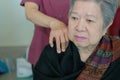 physiotherapist massage old woman shoulder