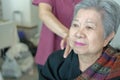 physiotherapist massage old woman shoulder