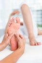 Physiotherapist massaging her patients foot