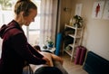 Physiotherapist massaging lower side of patient lying on foldout bed in sports studio. Royalty Free Stock Photo