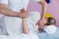 Physiotherapist massaging a senior womans shoulder