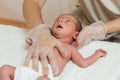 Physiotherapist performing an evaluation of the occipital mobility in a newborn baby.