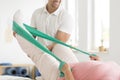 Physiotherapist performing exercises with patient