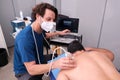 Physiotherapist performing an ultrasound on a patient`s back