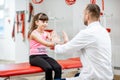 Physiotherapist with junior girl in the rehabilitation clinic Royalty Free Stock Photo