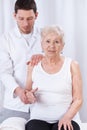 Physiotherapist practicing with elder woman Royalty Free Stock Photo