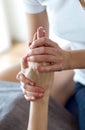 Physiotherapist pressing specific spots on female palm.