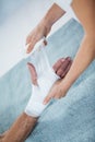 Physiotherapist putting bandage on injured hand of patient Royalty Free Stock Photo