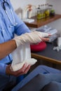Physiotherapist putting bandage on injured hand of patient Royalty Free Stock Photo