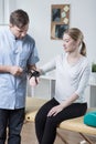 Physiotherapist putting orthosis on hand Royalty Free Stock Photo