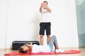 Physiotherapist showing woman an exercise Royalty Free Stock Photo