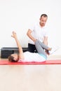 Physiotherapist showing woman an exercise Royalty Free Stock Photo