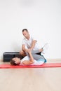 Physiotherapist showing woman an exercise Royalty Free Stock Photo